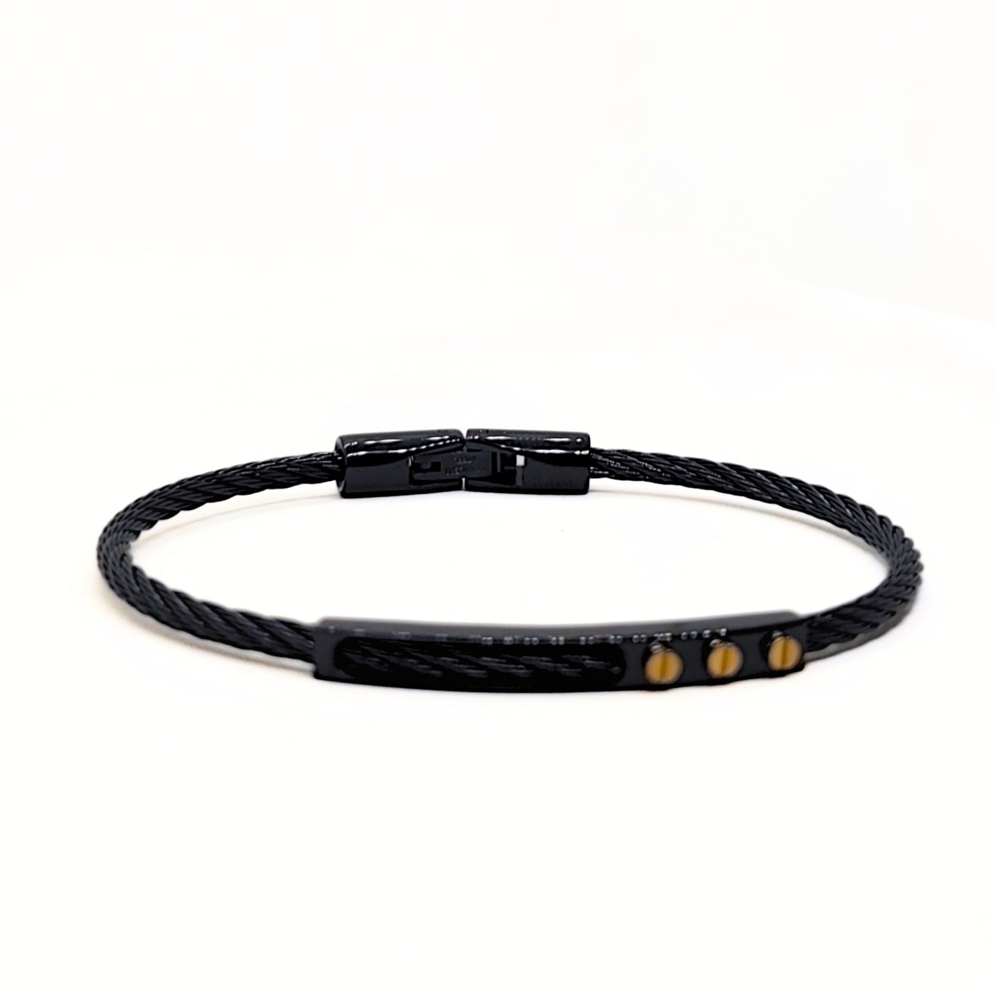 Black braided bracelet with gold accents on a white background