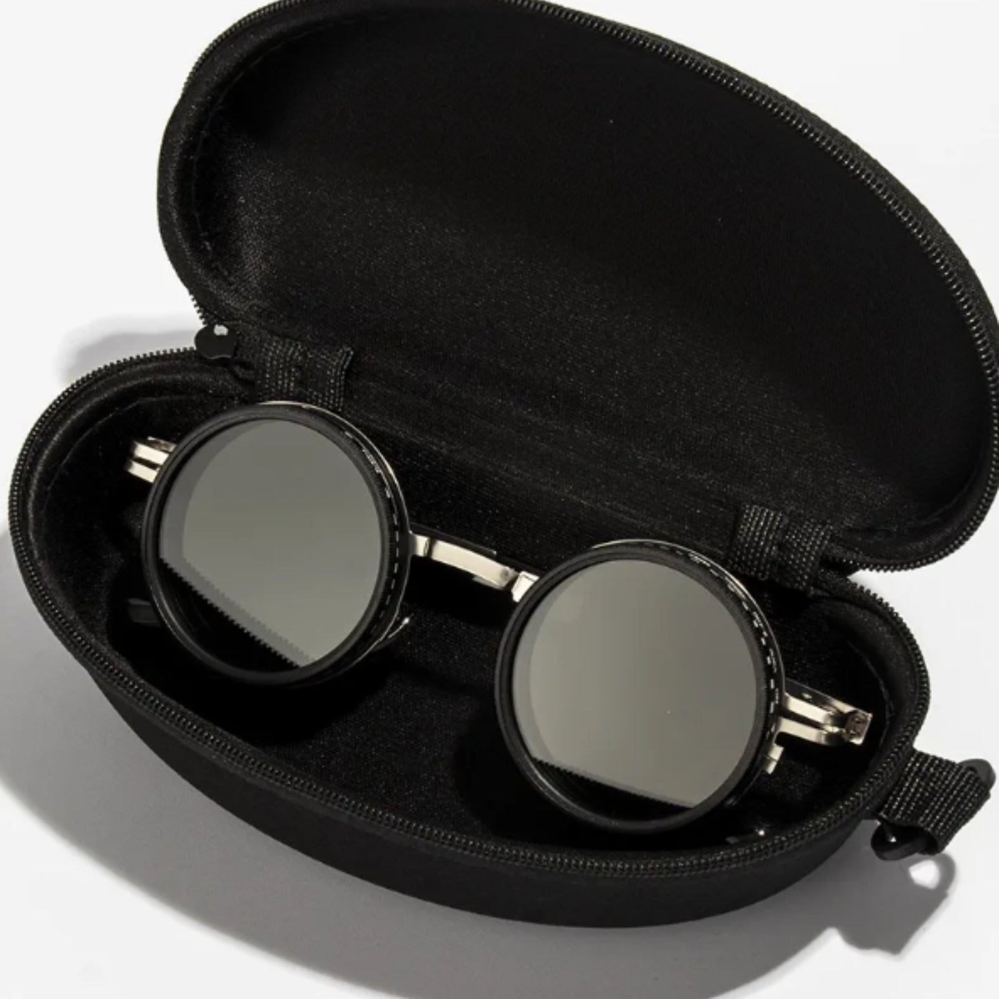 Black zippered case containing round sunglasses with dark lenses from the Summit Authority Bundle G-11 SG-002 by Overpowered
