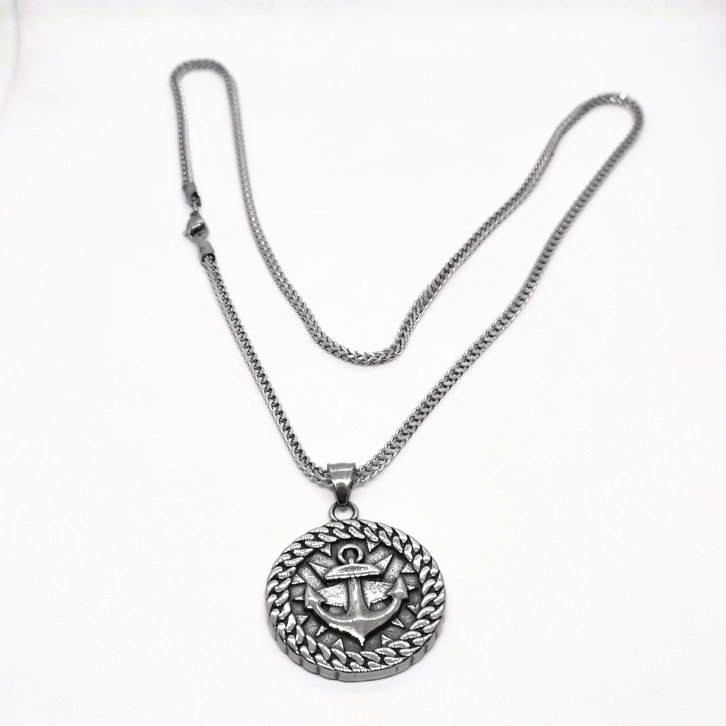 Silver steel necklace featuring an anchor pendant with a decorative circular design, from Overpowered Accessories.