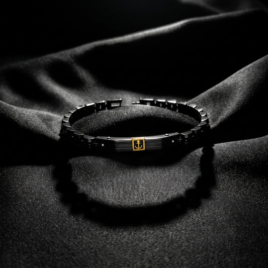 Men's stainless steel bracelet with black links and gold anchor centerpiece