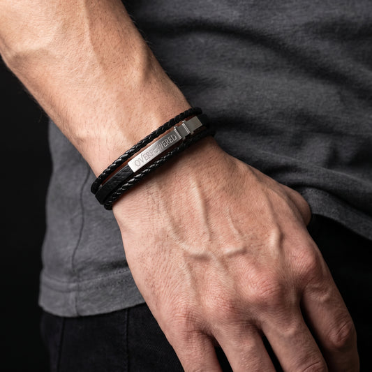 Adjustable black leather bracelet with silver clasp and engraved band text
