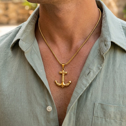 Gold steel anchor pendant necklace worn on the neck with braided chain