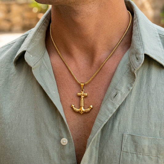 Gold steel anchor pendant necklace worn on the neck with braided chain