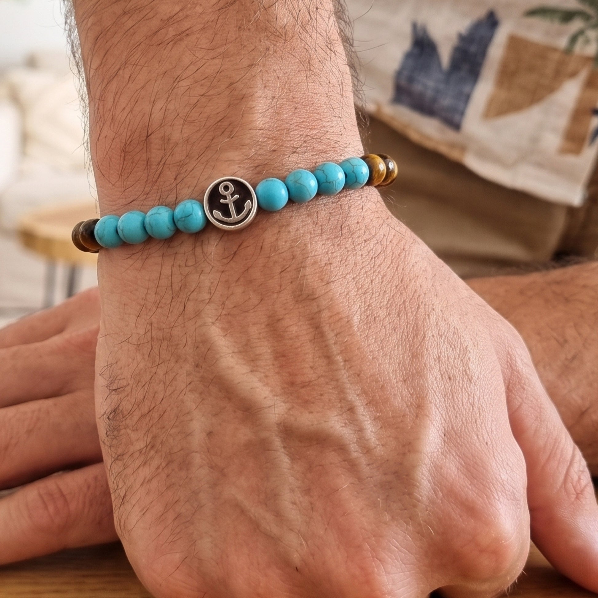 Men's tiger eye and turquoise anchor bracelet worn on wrist with round anchor charm