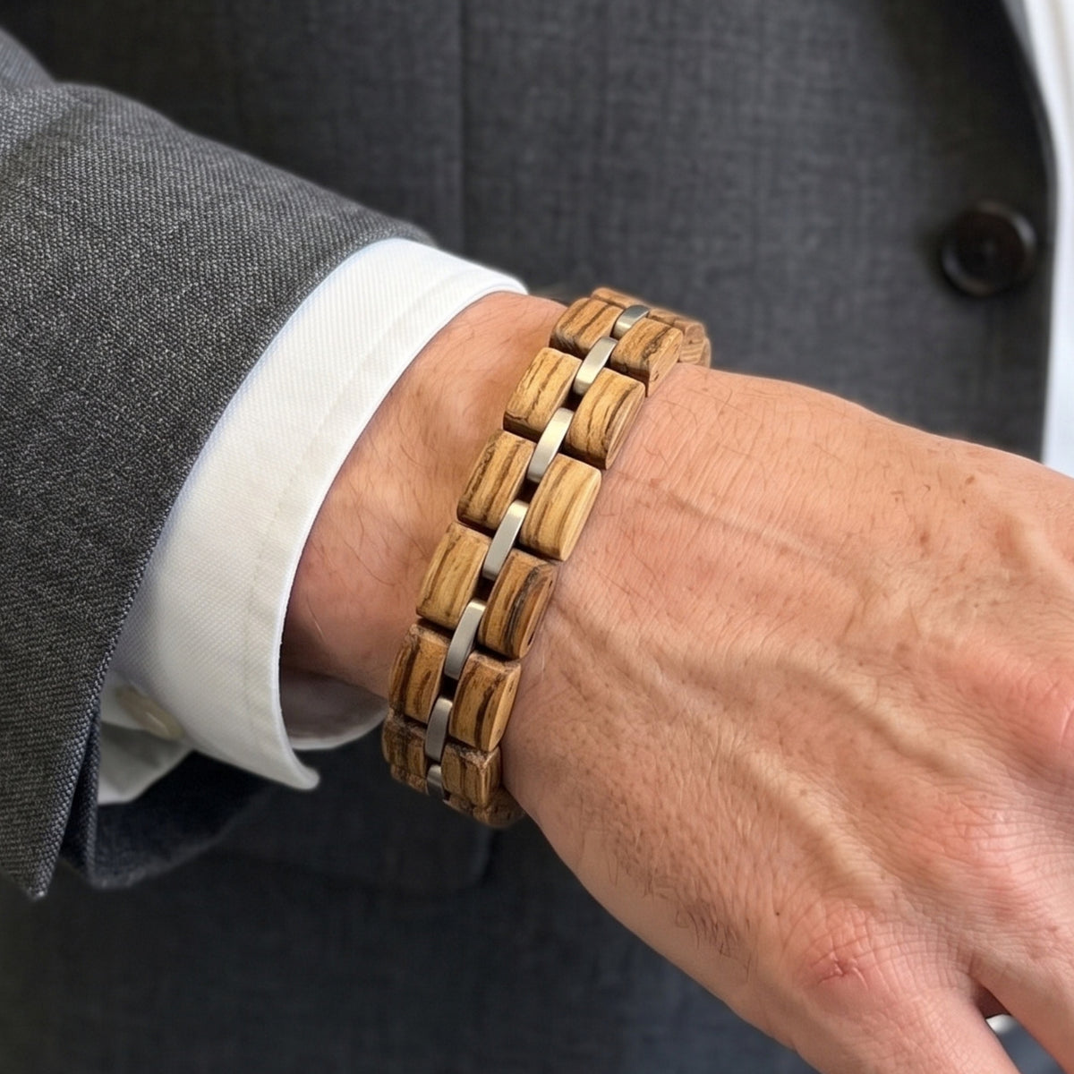 Close-up of zebrawood bracelet on man's wrist with silver connectors, Overpowered Accessories