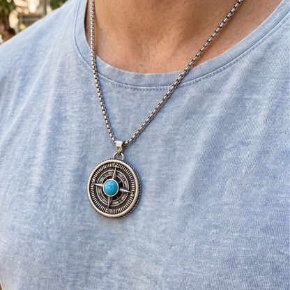 Turquoise compass pendant necklace worn on blue crewneck shirt