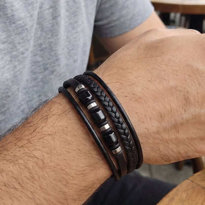 Men's black leather and braided bracelet with layered straps and metal beads