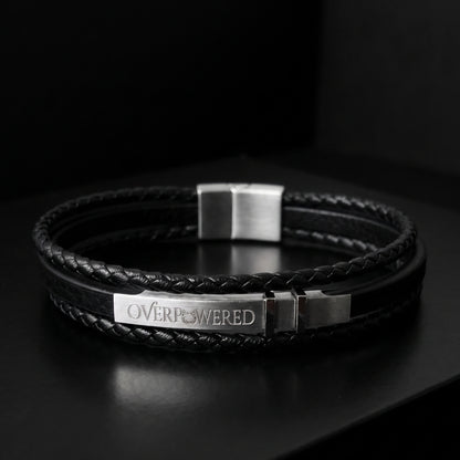 Black braided leather bracelet with engraved OVERPOWERED plate and silver buckle