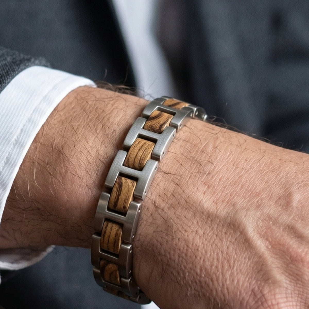 Men's stainless steel bracelet with zebrawood inlaid links, close-up on wrist, Overpowered Accessories