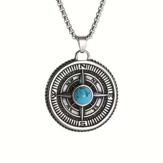 Compass-style pendant necklace with round silver-tone disc and blue turquoise cabochon center