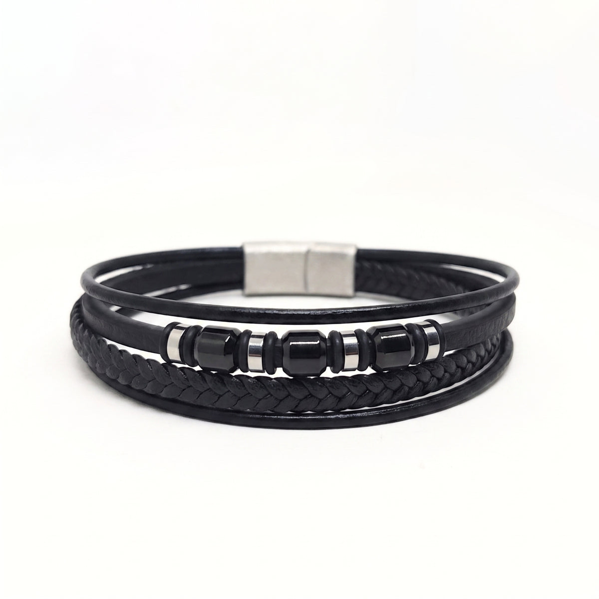 A black multi-strand leather bracelet featuring a braided section, smooth wrap-around cords, glossy black beads, and a silver-toned rectangular clasp, shown on a plain white background.