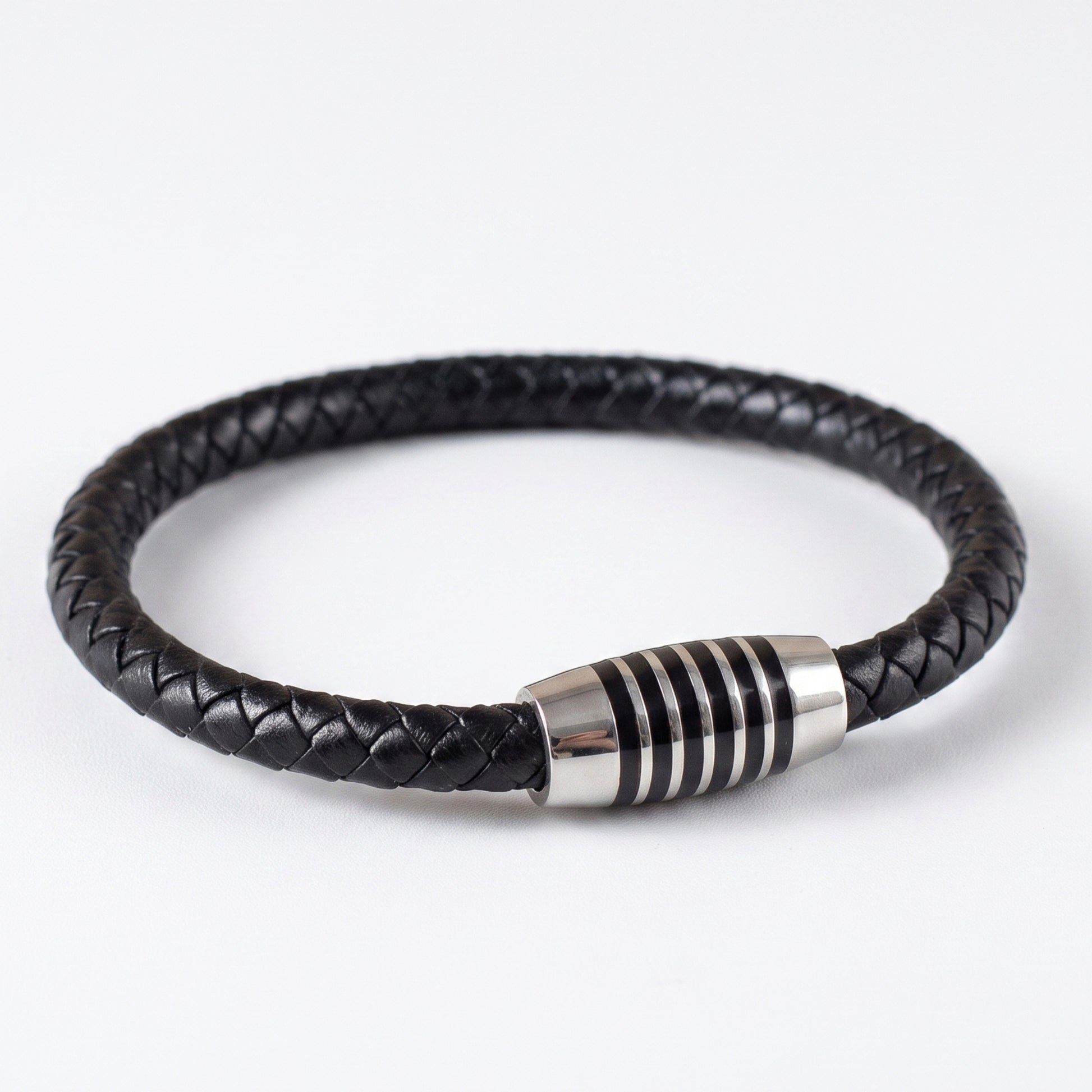 Black braided leather bracelet with silver-tone cylindrical magnetic-style clasp