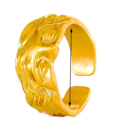 Gold sculpted face ring with open sides, raised facial features and hair relief