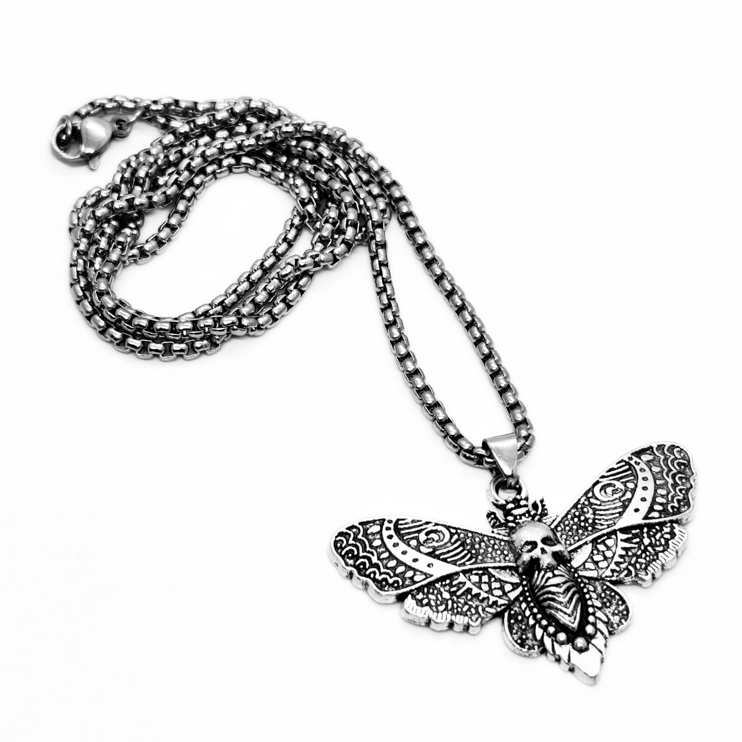 Silver-tone chain necklace with butterfly skull pendant, detailed filigree