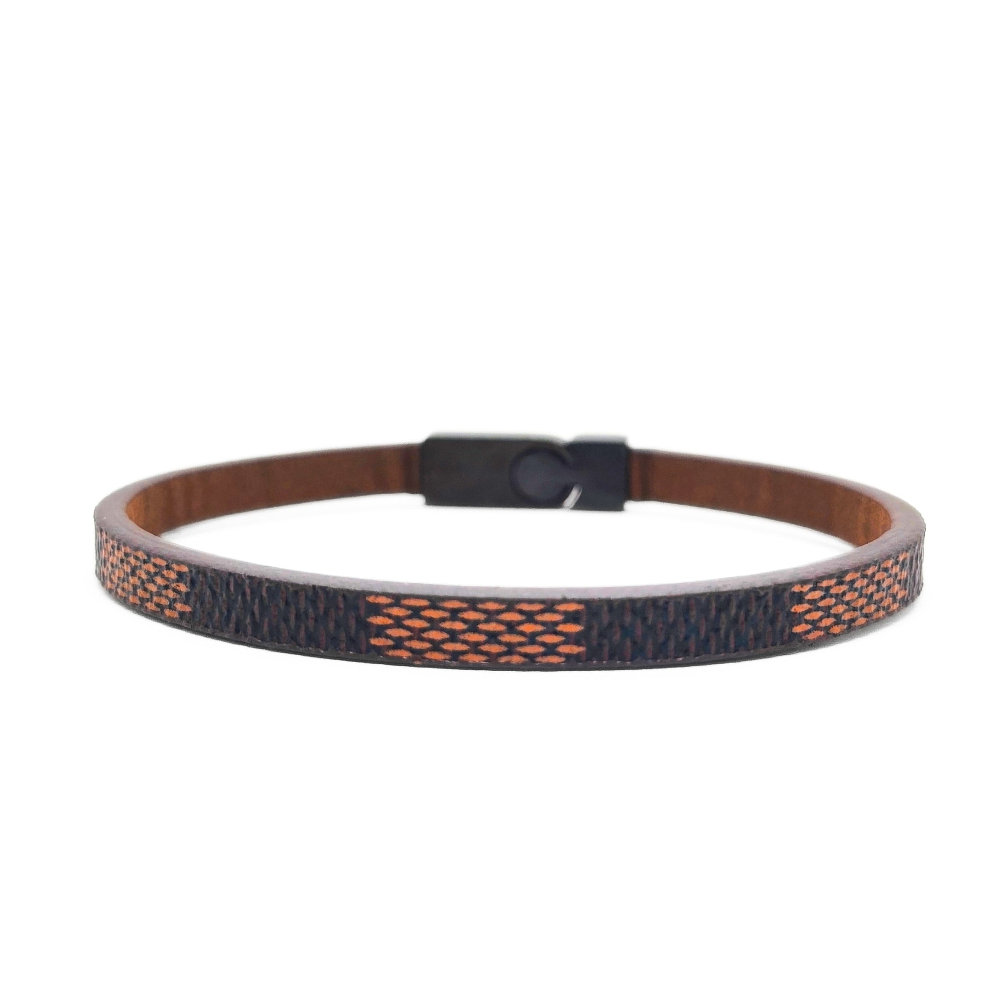 Men's brown leather bracelet with navy-orange woven strap and black clasp, side view