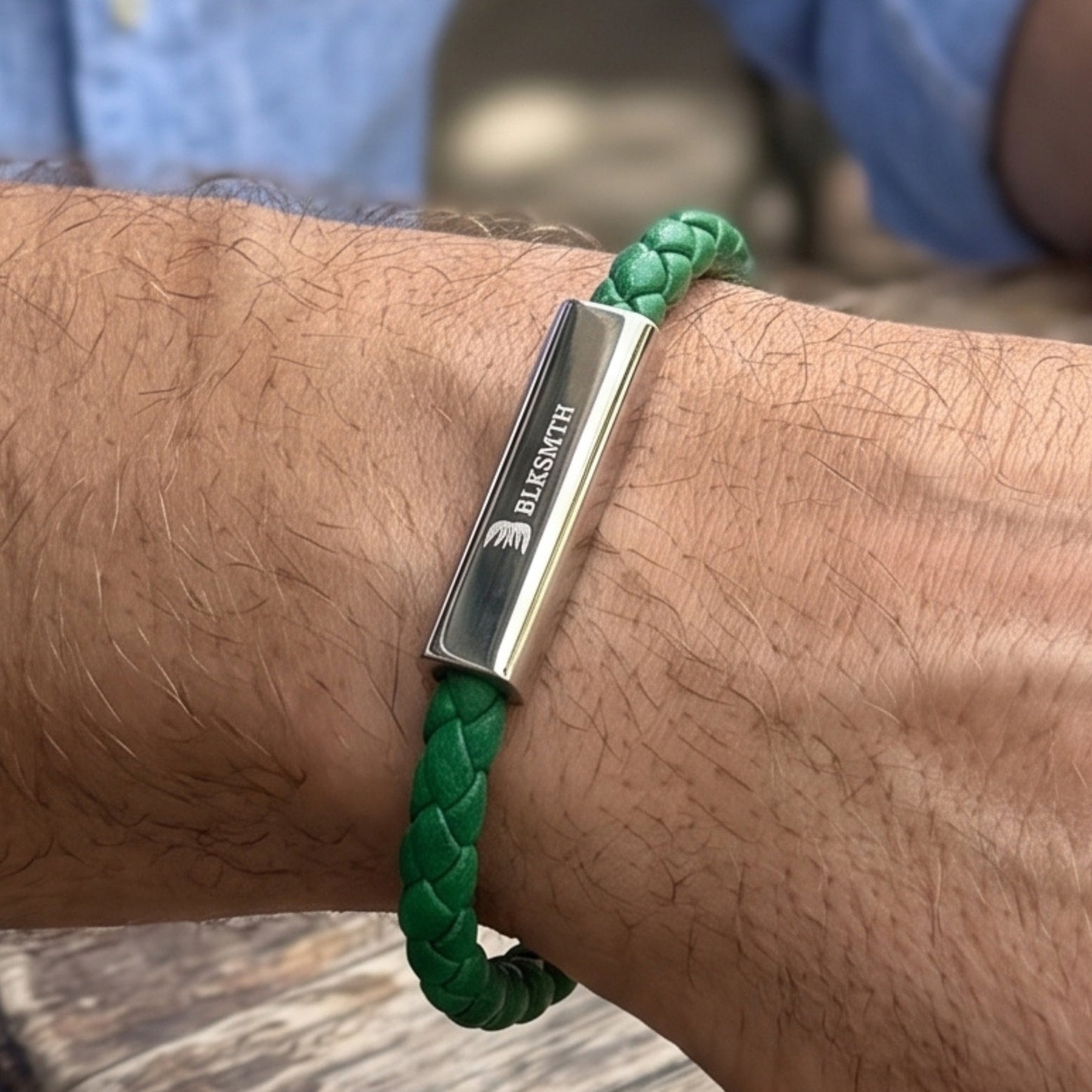 Green braided leather bracelet featuring a rectangular silver bar clasp