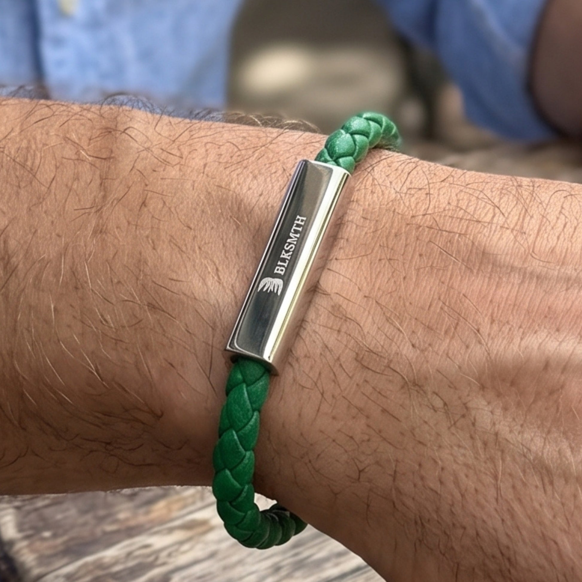 Green braided leather bracelet featuring a rectangular silver bar clasp