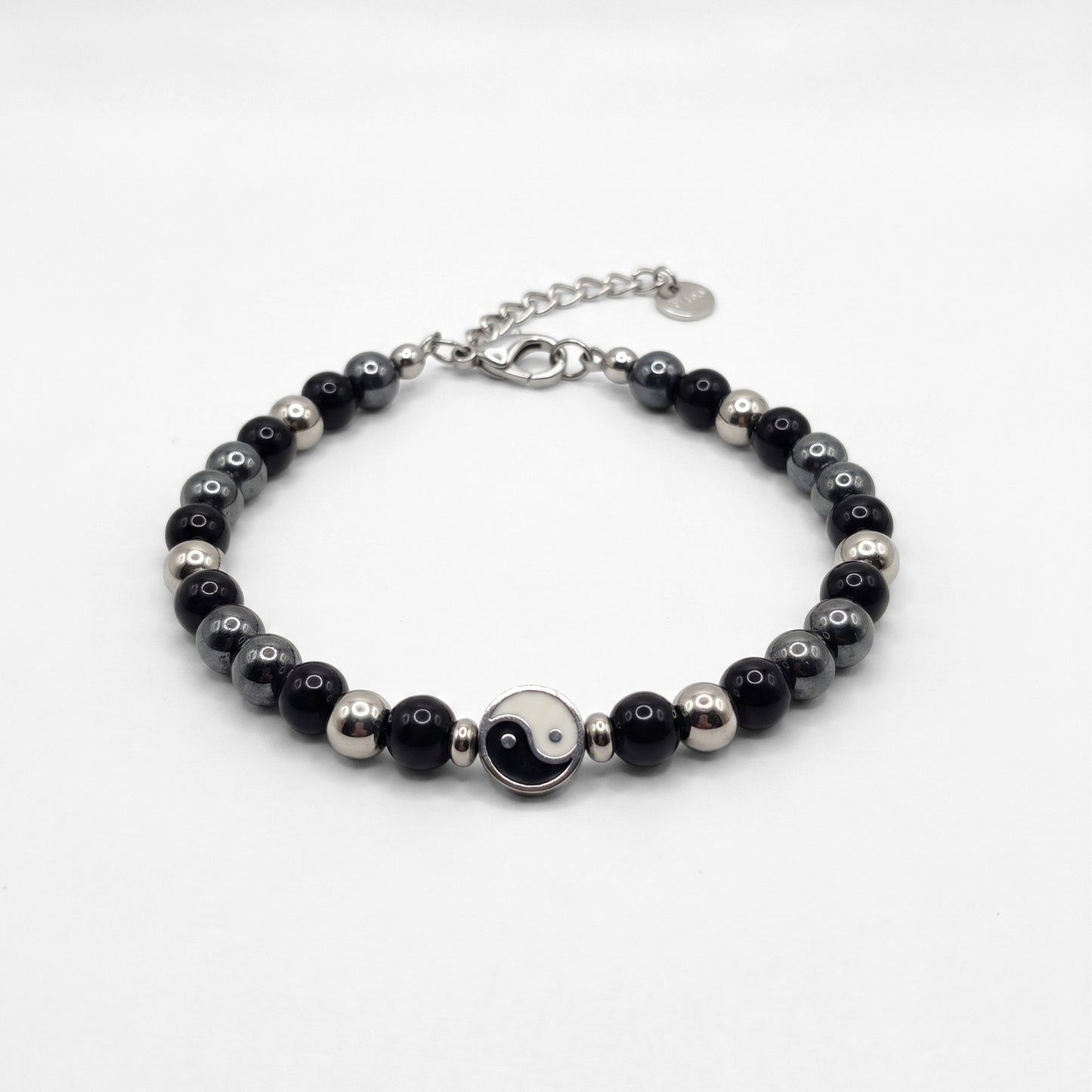 Black & silver beaded bracelet with yin-yang center charm and silver clasp