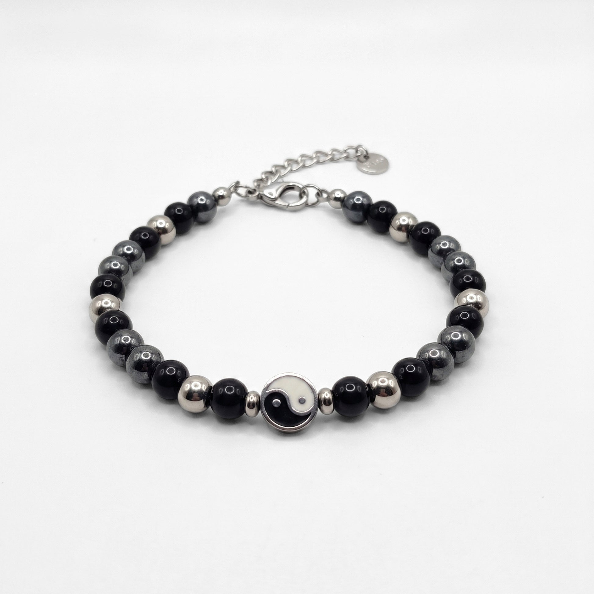 Black & silver beaded bracelet with yin-yang center charm and silver clasp