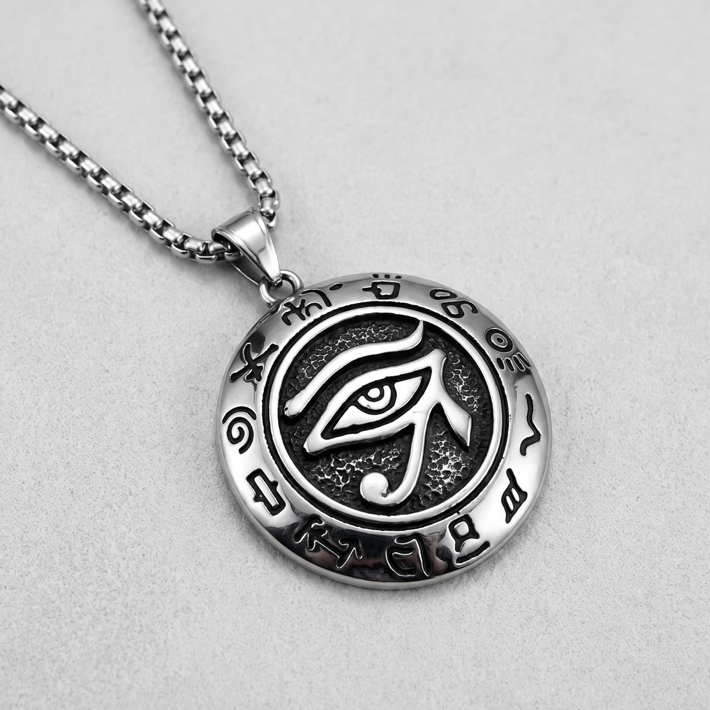 Oval eye pendant necklace on chain with black enamel design