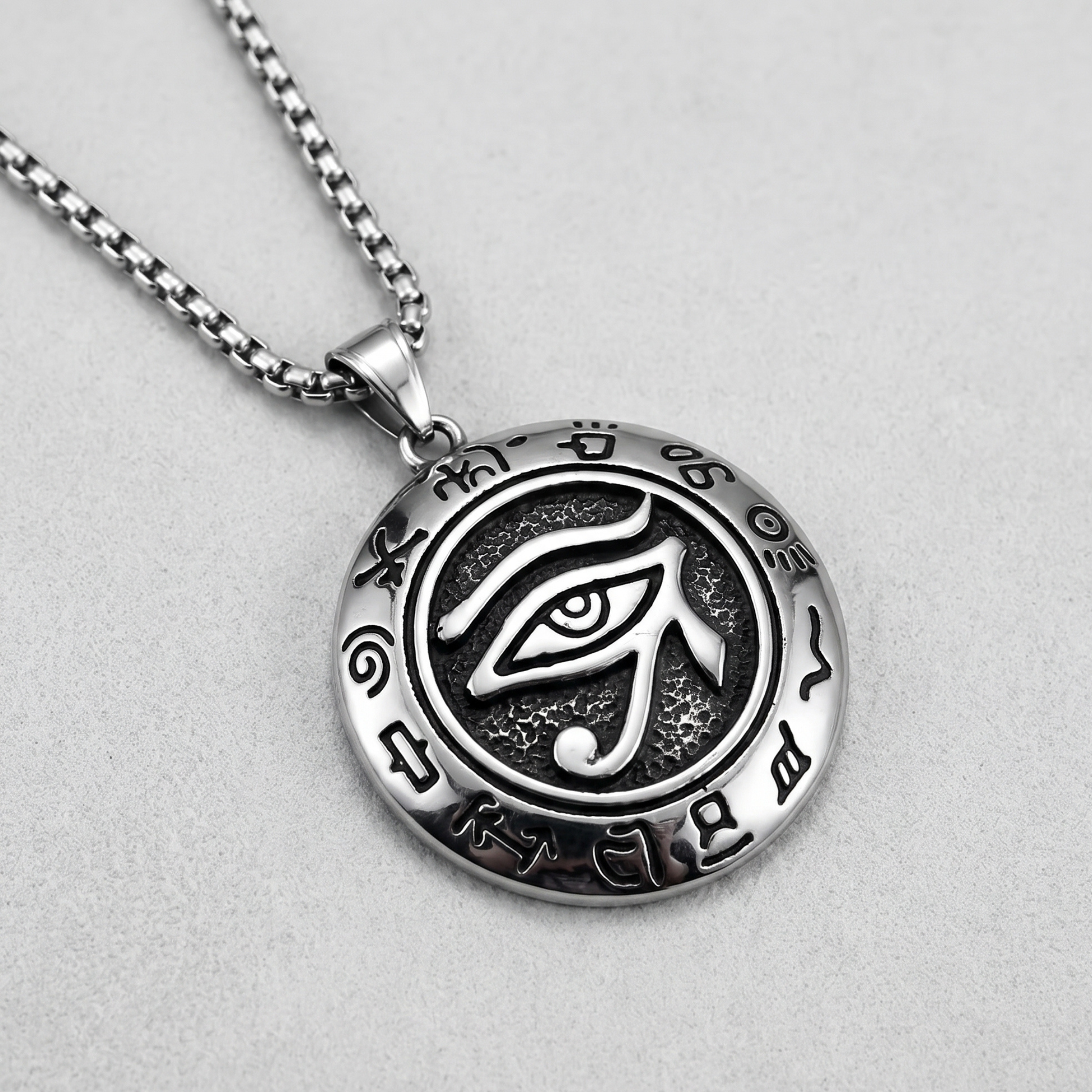 Oval eye pendant necklace on chain with black enamel design