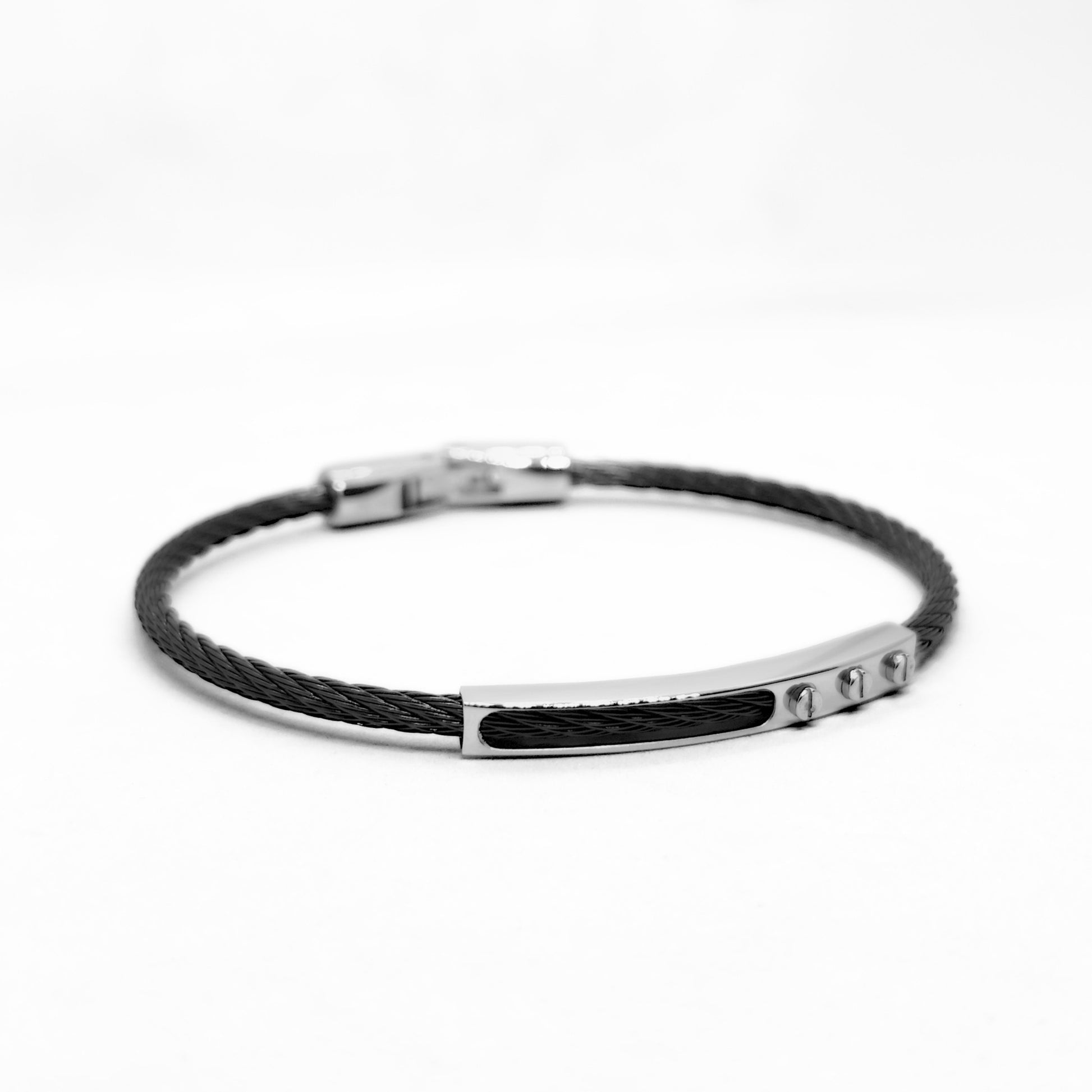 Black braided bracelet with silver clasp on a white background