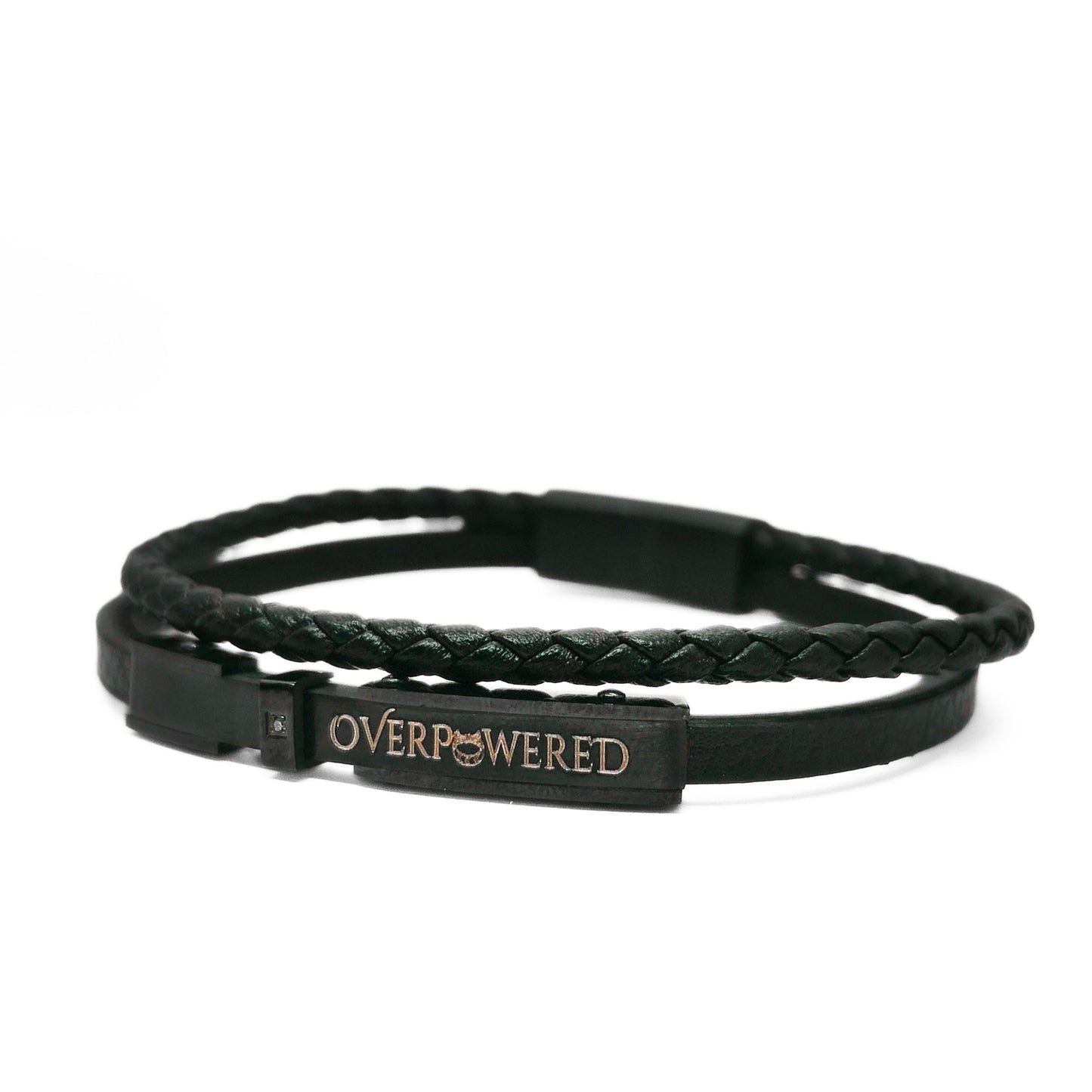A black double-strand bracelet featuring a braided top layer and a smooth bottom layer with a rectangular metal plate engraved with the word 'OVERPOWERED' in gold.