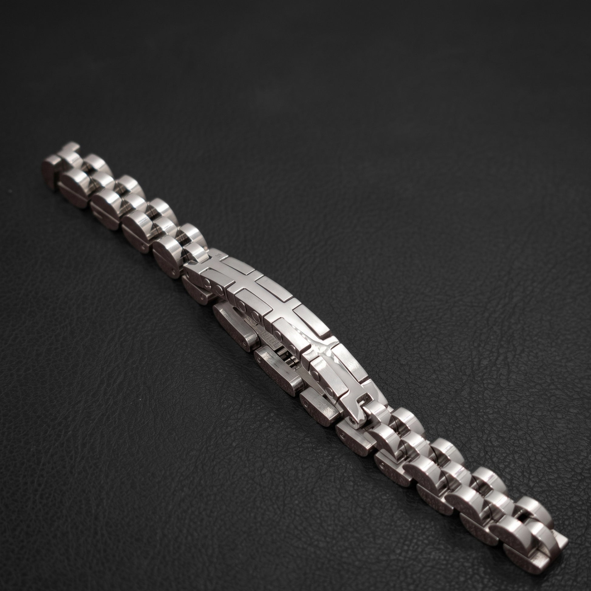 Silver and dark-toned stainless steel bracelet with X cross center panel