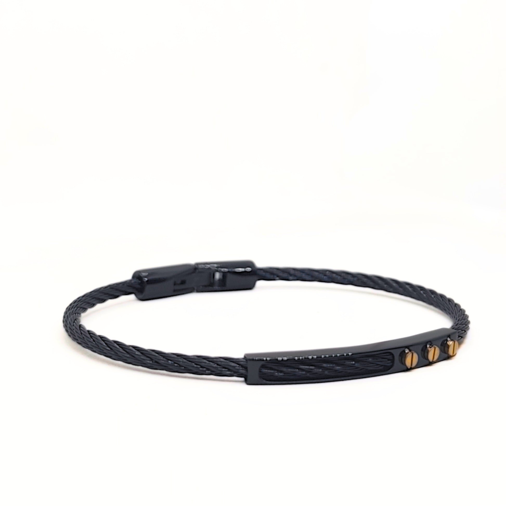 Black braided bracelet with gold accents on a white background