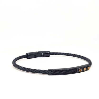 Black braided bracelet with gold accents on a white background