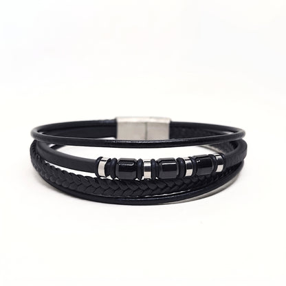 A black multi-strand leather bracelet featuring a braided section, smooth loops, glossy black beads, and a silver-toned rectangular clasp, shown on a plain white background.