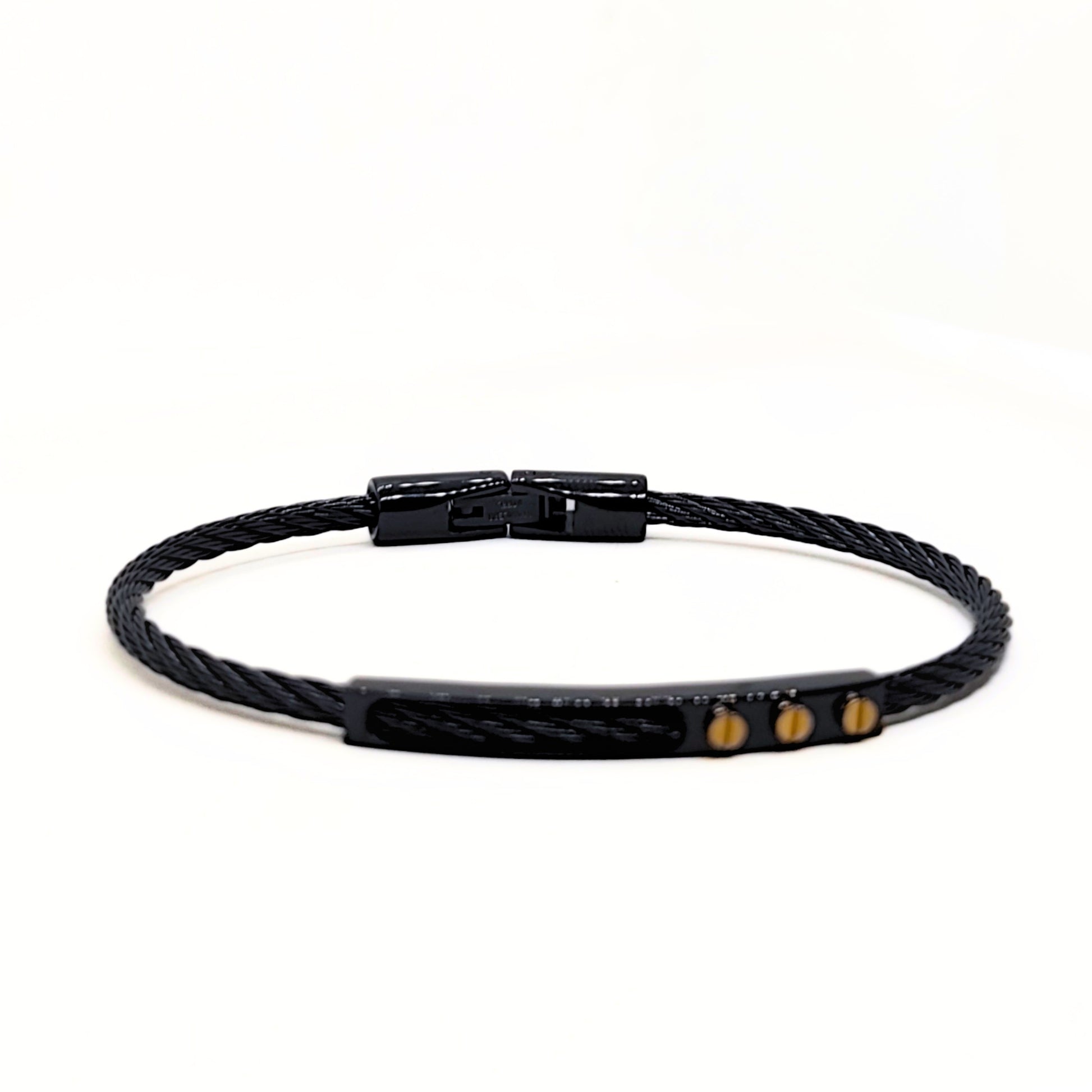 Black braided bracelet with gold accents on a white background