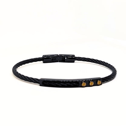 Black braided bracelet with gold accents on a white background