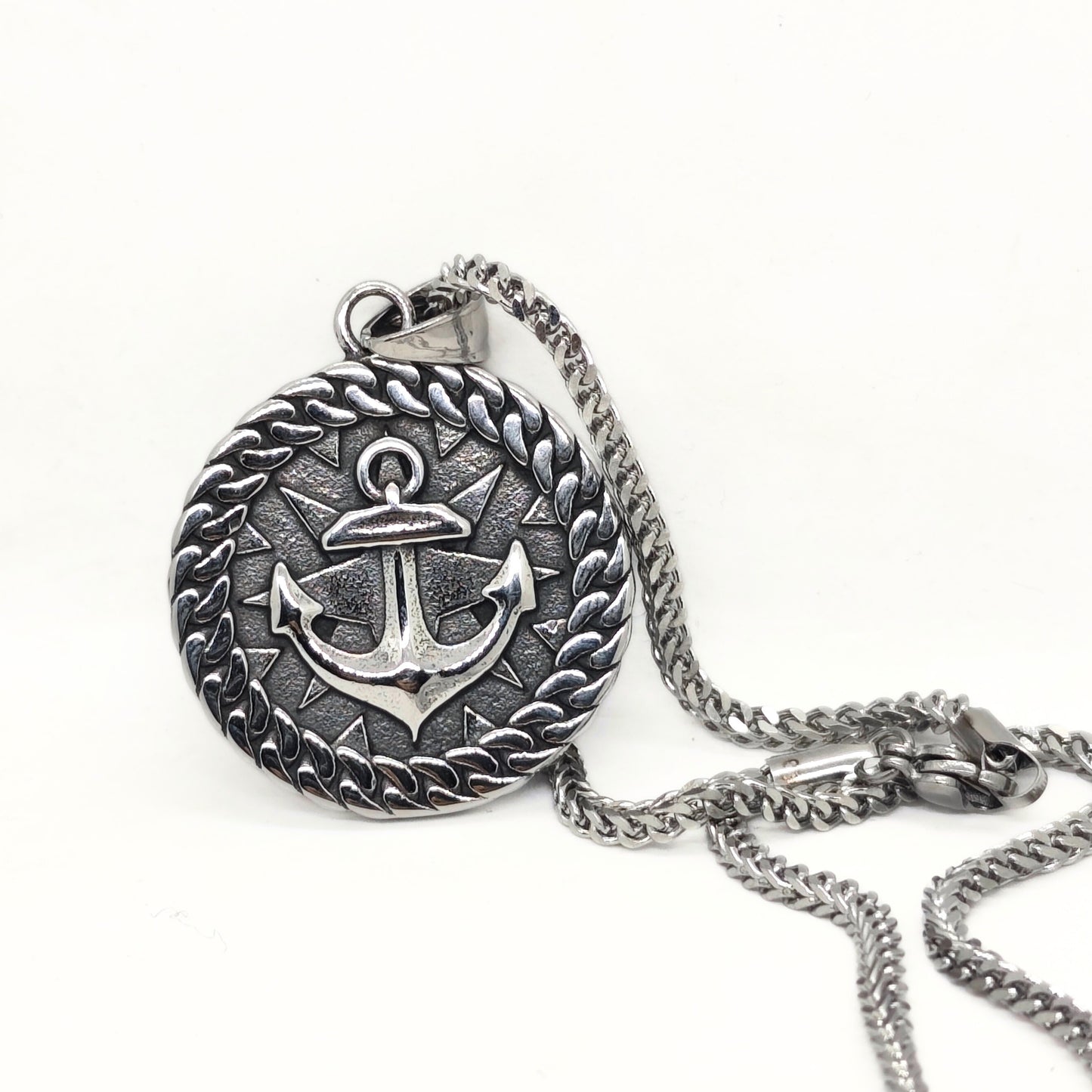 Silver steel anchor pendant necklace with a braided border, featuring a detailed anchor design, by Overpowered Accessories.