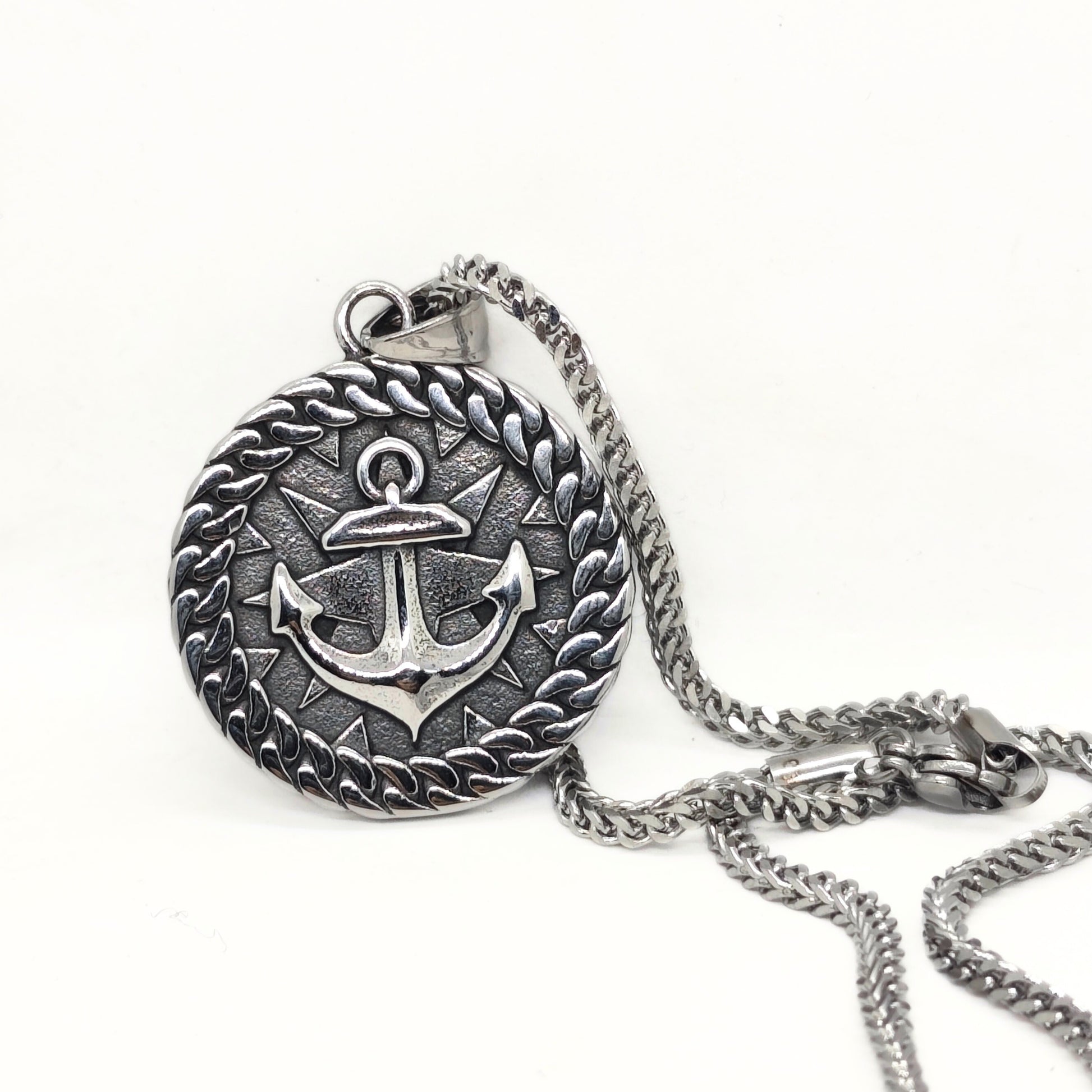 Silver steel anchor pendant necklace with a braided border, featuring a detailed anchor design, by Overpowered Accessories.