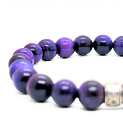 Close-up of purple and black tiger's eye bead bracelet with silver-tone cube clasp