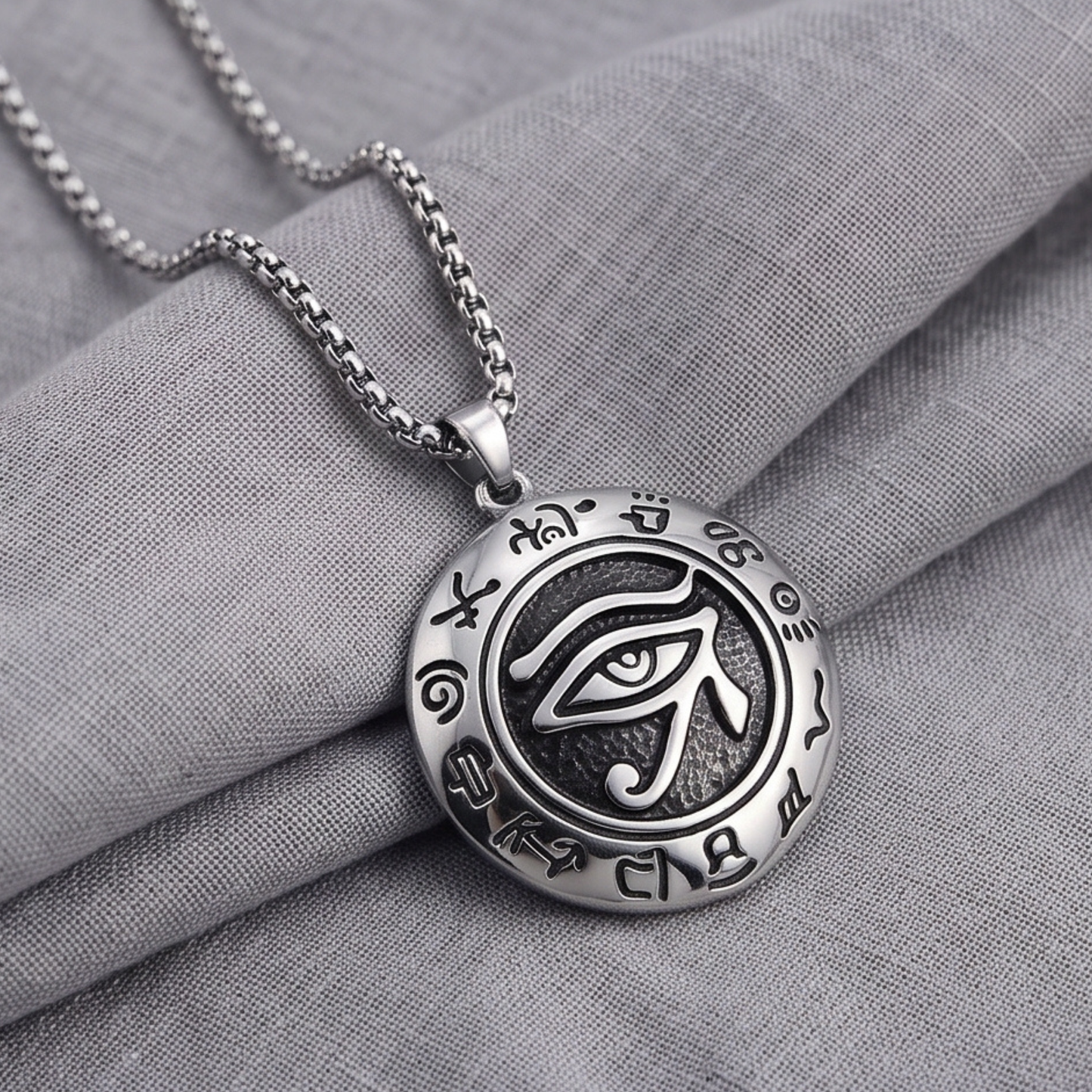 Oval eye pendant necklace on silver chain, detailed emblem