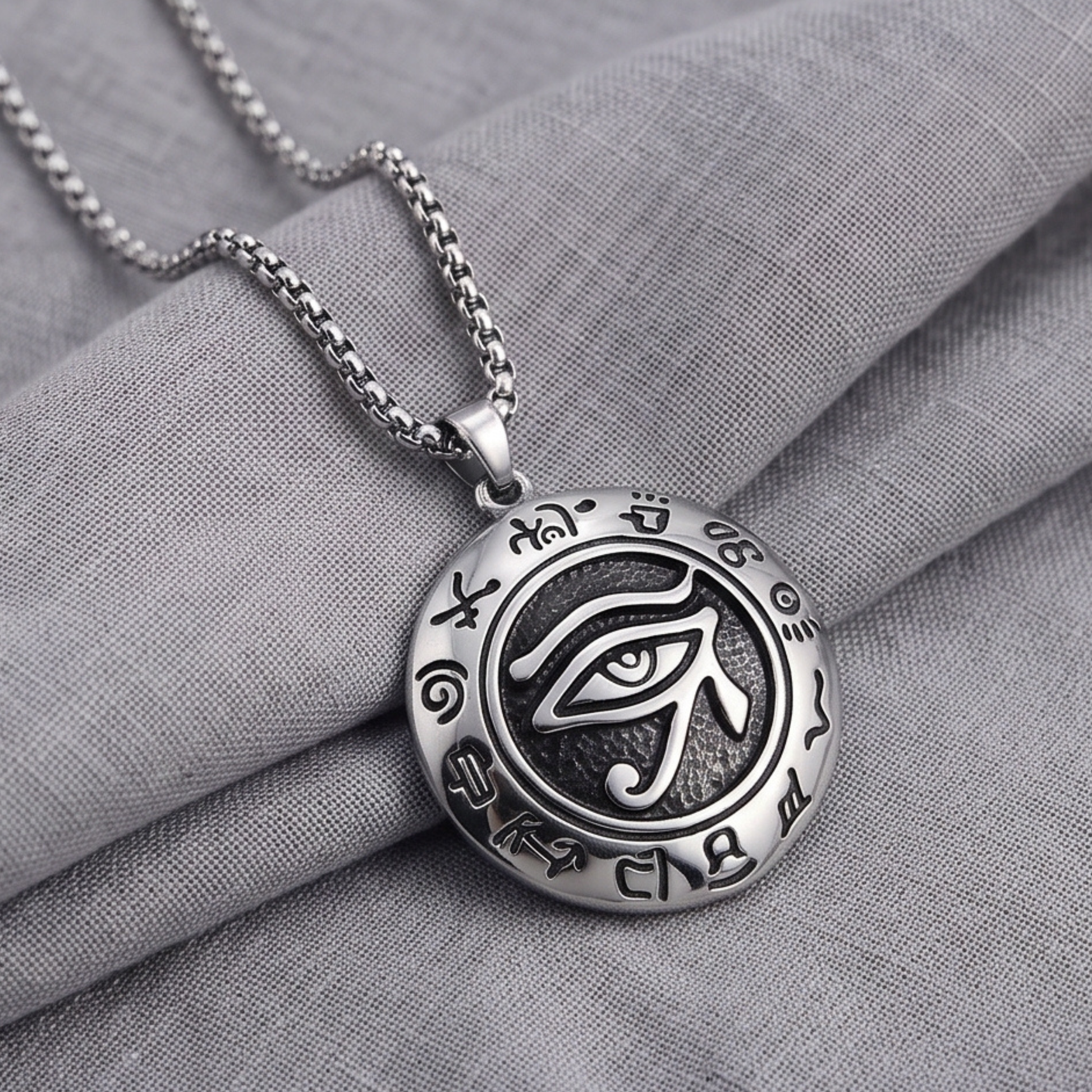 Oval eye pendant necklace on silver chain, detailed emblem
