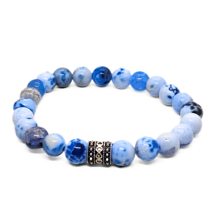 Round blue agate bead bracelet with black engraved metal ring spacer between beads.