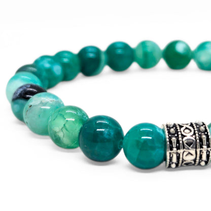 Green agate bead bracelet featuring an ornate silver-tone barrel spacer