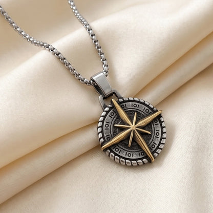 Two-tone compass pendant necklace with silver chain and gold star compass detail