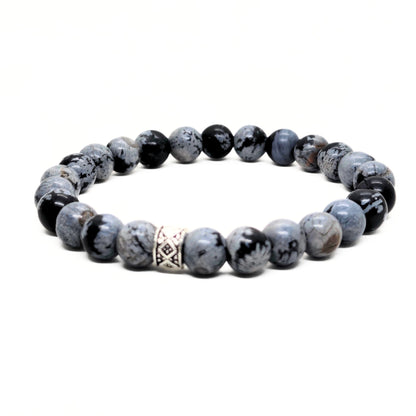 Gray and black obsidian bead bracelet with a silver geometric spacer and polished round stones