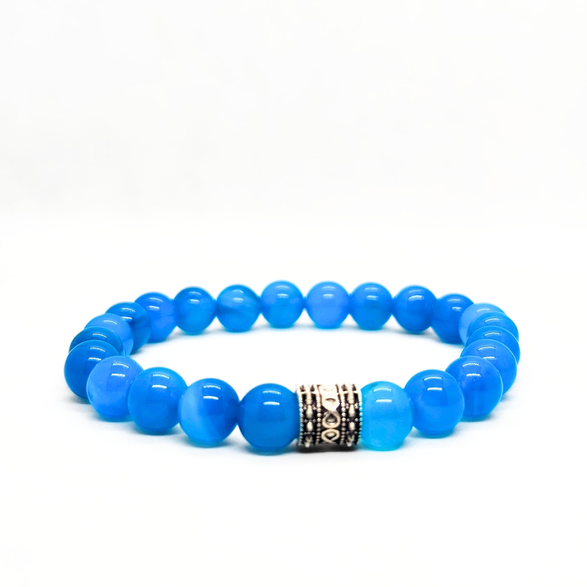 Blue agate bead bracelet featuring a dark engraved metal centerpiece.