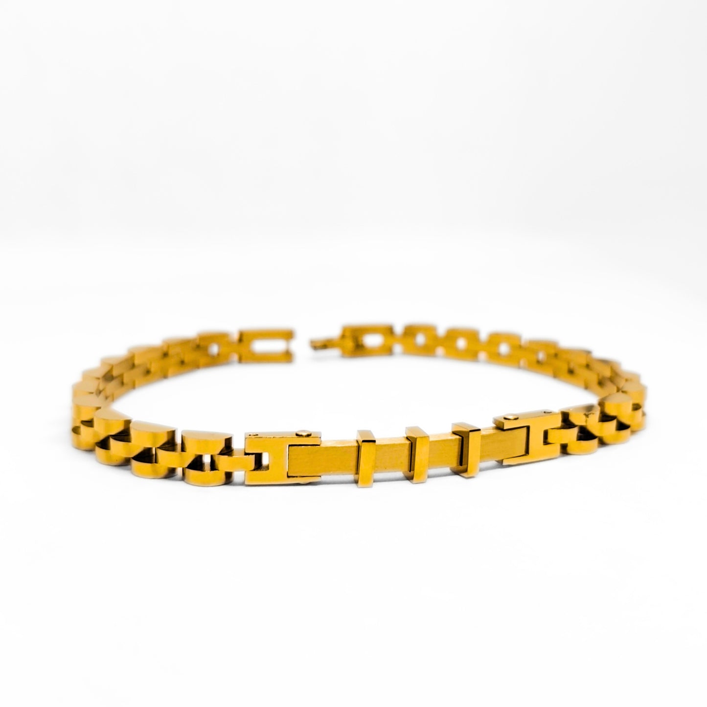 Gold stainless steel bracelet with alternating bar links and dark inset details