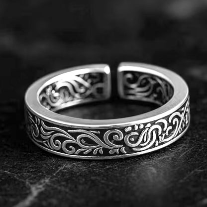Silver tone band ring with black filigree scrolls across the outer face