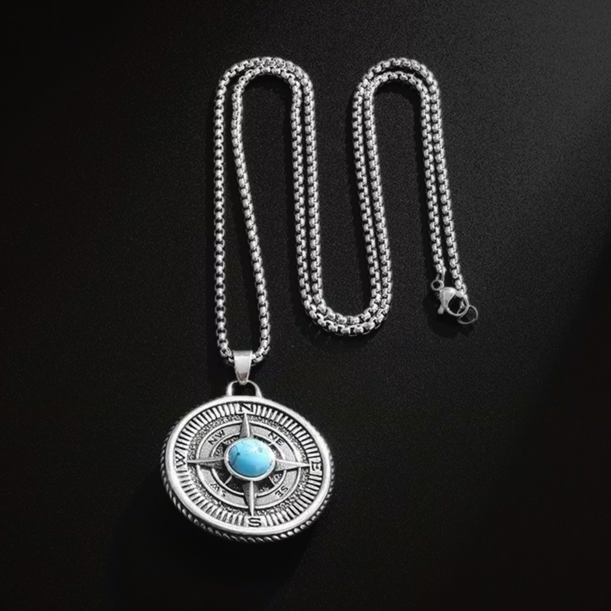 Silver chain pendant necklace featuring round compass disc with blue turquoise center stone