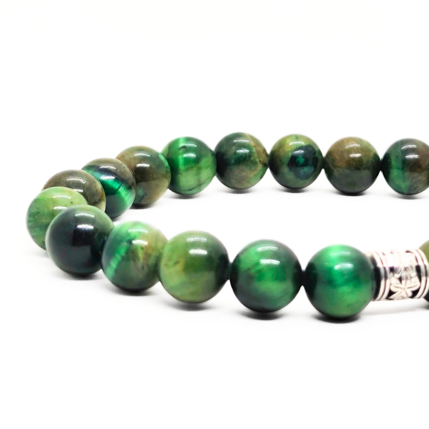 Close-up green tiger's eye bead bracelet with silver-toned clasp at side.