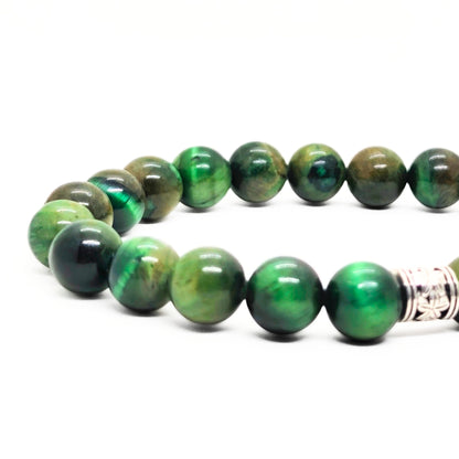 Close-up green tiger's eye bead bracelet with silver-toned clasp at side.