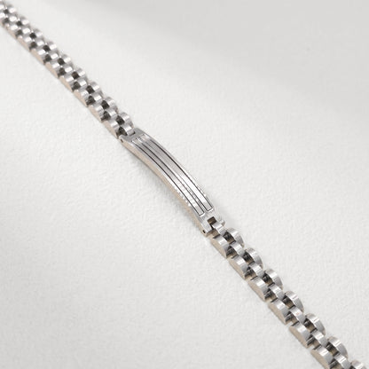 Close-up of silver stainless steel bracelet center panel with engraved horizontal lines