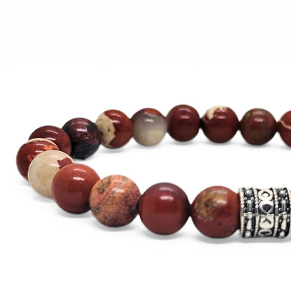 Close-up of red jasper beaded bracelet with silver-tone center clasp and speckled marbled stones